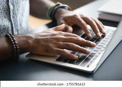 Close up image african male hands typing on laptop keyboard. Businessman answer on client e-mail, customer buying on-line using webshop easy and comfortable services modern wireless tech usage concept