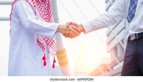 Close Up Image Of Arab Business Man Are Shaking Hand In The Cityscape Background, Partnership,collaboration,business Teamwork Concept.