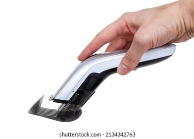 Close Up Image Of Arm Holding Hair Clipper, Isolated On White Background, An Electric Hair Clipper In Hand For Hairdressers, The Barber Machine Clippers Instead Of Scissors
