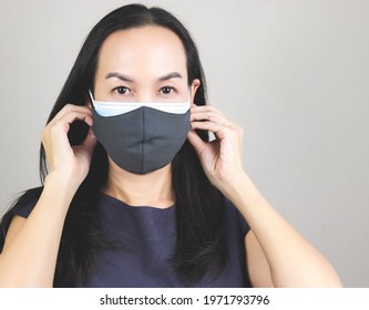 Close Up Image Of Asian Woman Wearing  Double Face Masks  Or Two Face Masks For Better Protection  From Coronavirus Or Covid-19 Outbreak - Concept Of Safety, Healthcare, Medical And Hygiene.