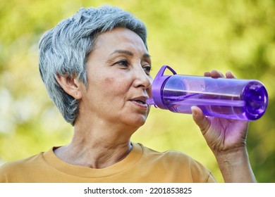 Close Up Image Attractive Mature Woman Holds Plastic Reusable Bottle Make Sip Drinking Still Mineral Water During Morning Work Out Or Stroll In Summer Park, Caring About Health, Relieving Thirst