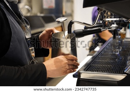 Close up image of a barista making specialty coffee using a professional machine. Process of brew coffee making in a coffee house.