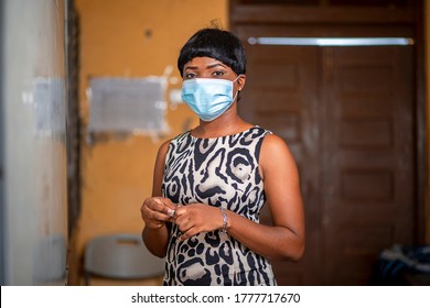 Close Up Image Of A Beautiful African Tutor In Front Of A Marker Board-black Lady In Face Mask In A Class Room With  Marker After Covid-19 Lock Down