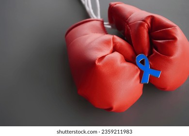 Close up image of boxing gloves and blue ribbon with copy space. Men's health, cancer awareness, stand against child abuse concept - Powered by Shutterstock