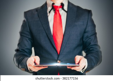 Close up image of business man holding a digital tablet 