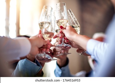 Close up image of business people toasting with champagne.