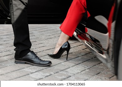 Close Up Image Of A Business Woman Getting Out Of Her Car With High Heels Shoes.