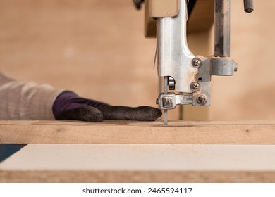 Close up image of carpenter hand using band saw in carpentry workshop
 - Powered by Shutterstock