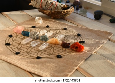 An close up image of chakra balancing crystals on a wooden table with glowing evening sunlight warming the crystals. 