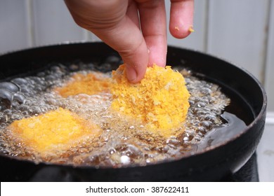 Close Up Image Of Chef Hand Putting Chicken Nuggets Tempura In To Hot Oil Pan For Deep Fry Cooking