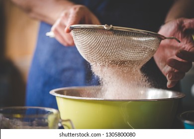 Close up image of a chef sifting together flour and ingredients to bake a delicious cake. - Powered by Shutterstock