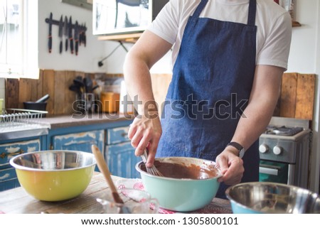 Close up image of a chef stirring cake batter for baking a cake.