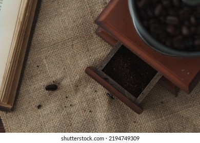 Close Up Image Of A Coffee Grinder. The Drawer Is Open Showing Ground Coffee. Brown Monochromatic Rustic Food Photo With Copy Space