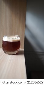 Close Up Image Of Coffee Mocktail On Wooden Table