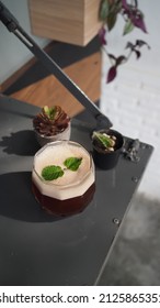 Close Up Image Of Coffee Mocktail On Wooden Table