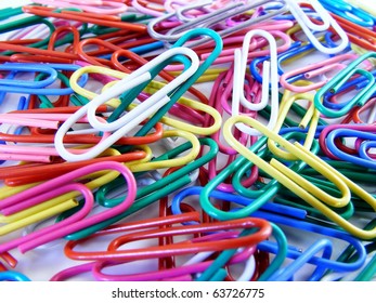 A Close Up Image Of Colored Paper Clips In A Pile