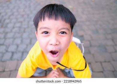 Close Up Image Of Cute Asian Boy Looking At Camera With Happy And Excited Face With Mask Off His Face