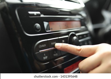 Close Up Image Of Driver's Hand Press Button On Car Radio, Listening Music During Trip Concept