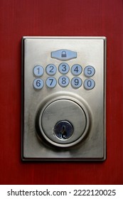 A Close Up Image Of An Electronic Keypad Entry System On A Bright Red Door. 