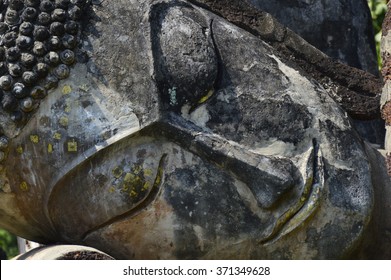 A close up image of the face of a Buddha statue.Defocused - Powered by Shutterstock