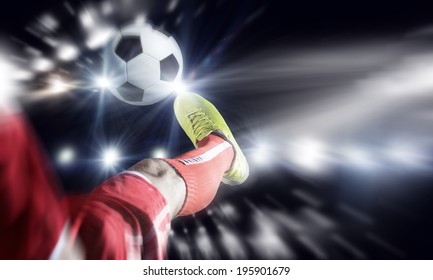 Close up image of footballer foot kicking the ball
