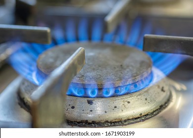 Close Up Image Of Gas Flame Burning On Domestic Kitchen Hob.Global Warming Issue.Rising Energy Prices UK.Fossil Fuels.Fuel And Power Industry.
