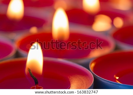 Close up image of glowing red tea lights