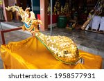 close up image of gold sheet stick on holy golden gable apex statue in Thai temple. (Publie Domain.)