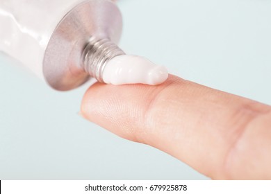 Close up image of hands with cream tube 