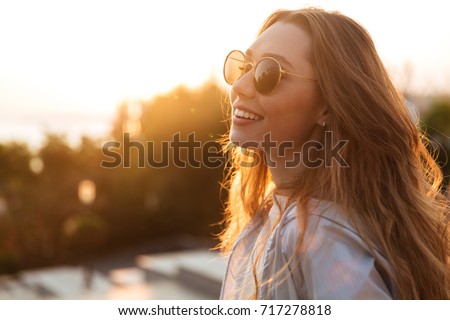 Similar – Image, Stock Photo Casual woman in sunglasses leaning against a brick wall