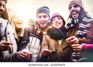 Close Up Image Of Happy Friends Enjoying Out With Sparklers - Group Of Young People Celebrating New Year Eve With Fireworks - Holidays And Friendship Concept