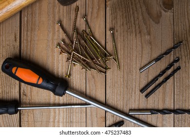 Close up image of hardware tools, screws and nails. Ready for a DIY project at home, on wooden background