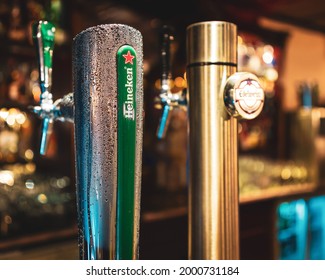 Close Up Image Of A Heineken Beer Dispenser Covered By Drops In A Bar.