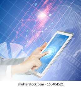 Close up image of human hand touching screen of tablet pc