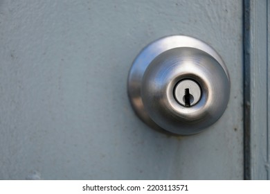 A Close Up Image Of The Key Hole On A Shiny Metal Industrial Door Handle.