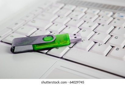 Close Up Image Of Laptop And Green Usb Memory Stick