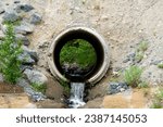 A close up image of a large concrete culvert redirecting waste water run off.