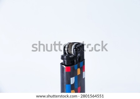 Close up image of a lighter with a white background.