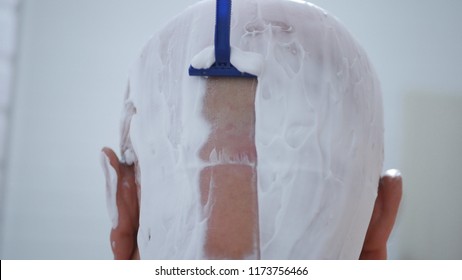 Close Image With Man Shaving His Head In Bathroom