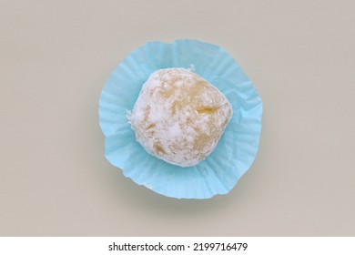 Close Up Image Of Mochi Cake Placed On Blue Paper Isolated On Creamy Background