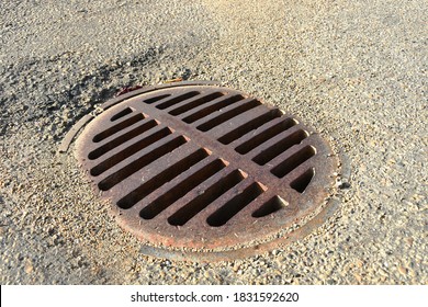 A Close Up Image Of An Old Rusted City Storm Drain Cover. 