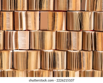 Close up image of opened stack pile heap collection old books hard cover attached to the wall pages. Photo zone decoration background. Library books in shop or photostudio, education concept.
 - Shutterstock ID 2226215107