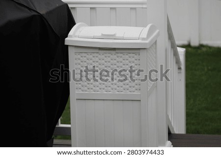 The close up image of an outdoor garbage pail.