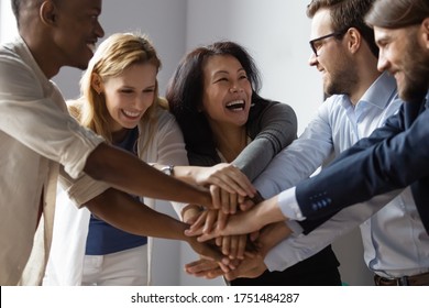 Close Up Image Overjoyed 5 Multi Ethnic Business People Stack Touch Arms Palms Together Celebrating Promotion Reward, Succeed Common Aim. Give High Five Symbol Of Unity, Team Building Activity Concept