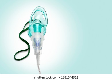 Close up image of an oxygen mask from front on green gradient. Clipping path for the mask - Powered by Shutterstock