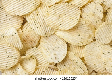 Close Up Image Of Pile Of Sour Cream And Onion Potato Chips