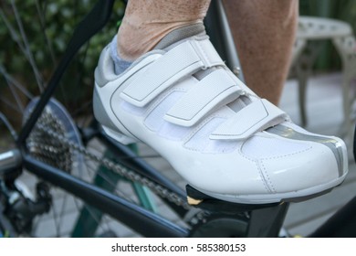 Close Up Image Of A Racing Shoe And Leg Attached To A Bike Pedal