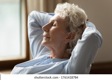 Close Up Image Side View Face Calm Old Woman Closed Eyes Put Hands Behind Head Falls Asleep In Cozy Living Room, Dream Enjoy Fresh Air And Comfortable Couch, Carefree Retired Life, No Stress Concept