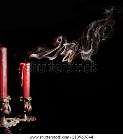 Close up image of smoke candle with smoke curve on black background