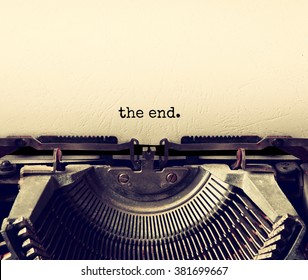 close up image of typewriter with paper sheet and the phrase: THE END . copy space for your text. retro filtered
